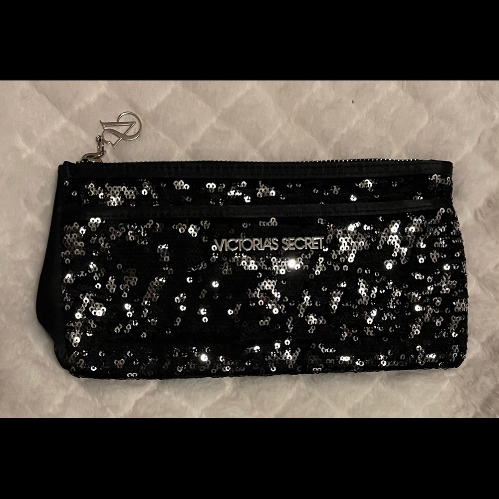 Victoria’s Secret black zipper clutch with sequins.
